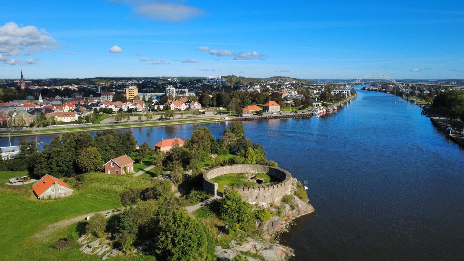 Luftfoto av Isegran og Glomma med Fredrikstad sentrum i bakgrunnen. Runde festningsmurer og elv i forgrunnen.